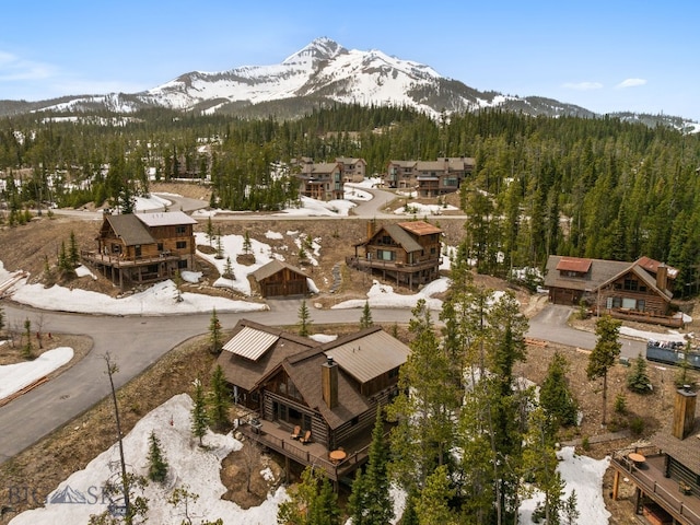 9 Manitou Loop Unit 45E, Big Sky, MT 59716 - aerial view of property and surrounding area with a mountain backdrop and a heavily wooded area