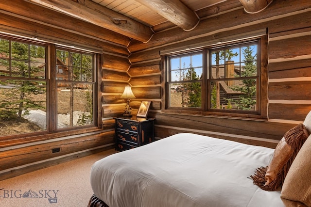 9 Manitou Loop Unit 45E, Big Sky, MT 59716 - bedroom with wood ceiling with exposed beams, log walls, and carpet flooring