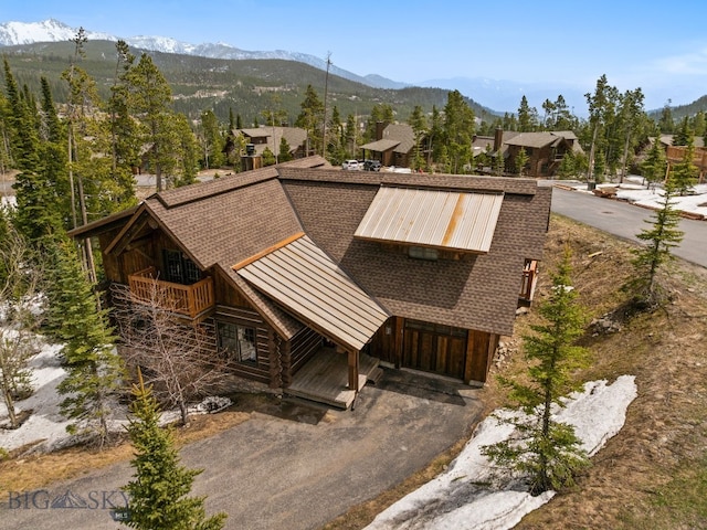 9 Manitou Loop Unit 45E, Big Sky, MT 59716 - view of front of home with a standing seam roof, metal roof, a mountain view, driveway, and a chimney
