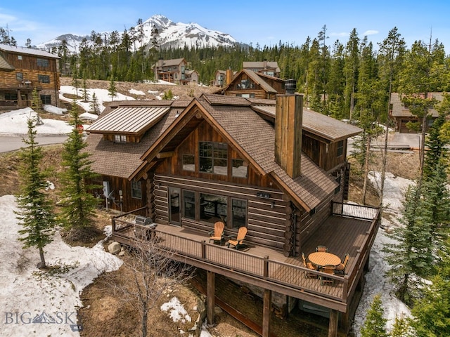 9 Manitou Loop Unit 45E, Big Sky, MT 59716 - rear view of house with log siding and a deck with mountain view