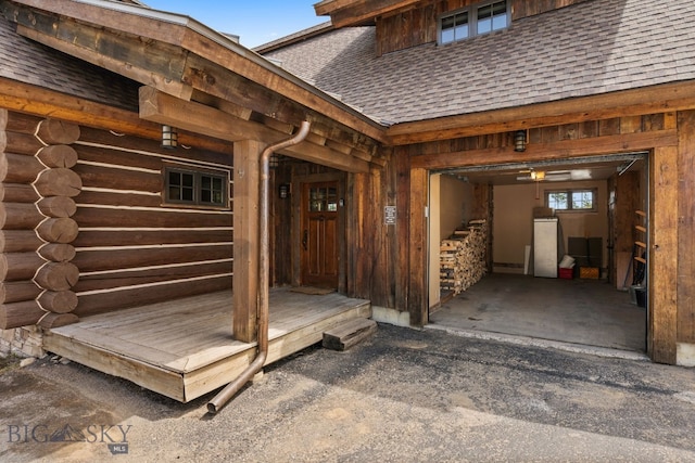 9 Manitou Loop Unit 45E, Big Sky, MT 59716 - view of exterior entry featuring roof with shingles and log siding