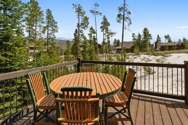 9 Manitou Loop Unit 45E, Big Sky, MT 59716 - wooden deck with outdoor dining area and a mountain view
