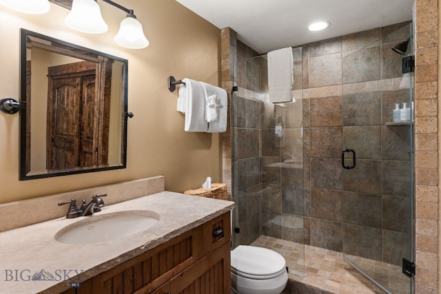 9 Manitou Loop Unit 45E, Big Sky, MT 59716 - bathroom with toilet, vanity, a stall shower, and recessed lighting