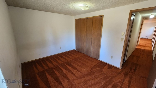 2 Kearney Ln, Sheridan, MT 59749 - unfurnished bedroom with carpet flooring, a closet, and a textured ceiling
