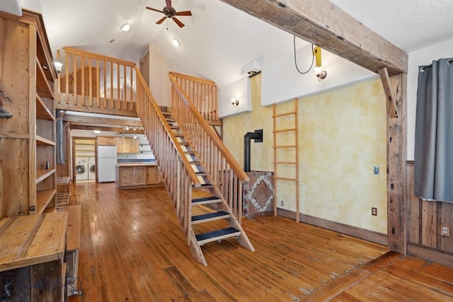 511 Alder St, Anaconda, MT 59711 - stairway featuring washing machine and dryer, a ceiling fan, hardwood / wood-style floors, and high vaulted ceiling