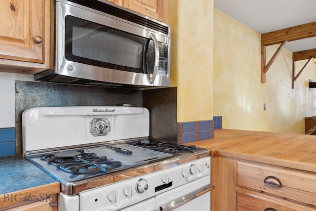 511 Alder St, Anaconda, MT 59711 - kitchen featuring stainless steel microwave, gas range oven, light countertops, and light brown cabinets