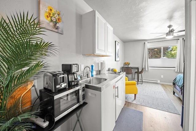 420 N 6th Ave, Bozeman, MT 59715 - kitchen with a sink, light wood finished floors, a ceiling fan, light countertops, and stainless steel microwave