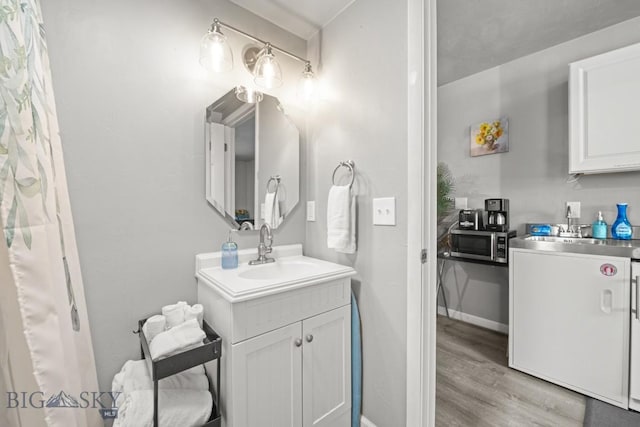 420 N 6th Ave, Bozeman, MT 59715 - bathroom with vanity, wood finished floors, and baseboards