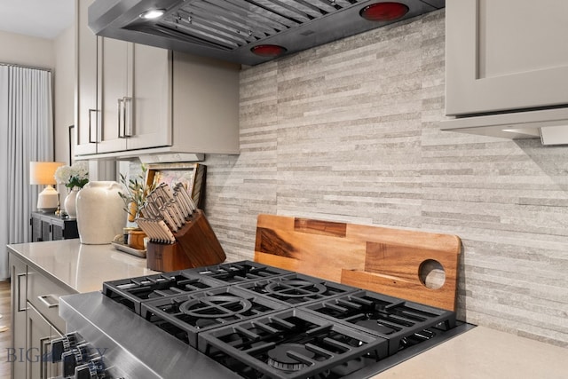 47 Wickwire, Bozeman, MT 59718 - kitchen featuring custom exhaust hood, light countertops, stove, and backsplash