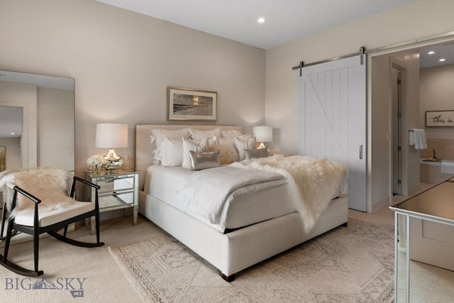 47 Wickwire, Bozeman, MT 59718 - bedroom featuring a barn door, recessed lighting, and light carpet