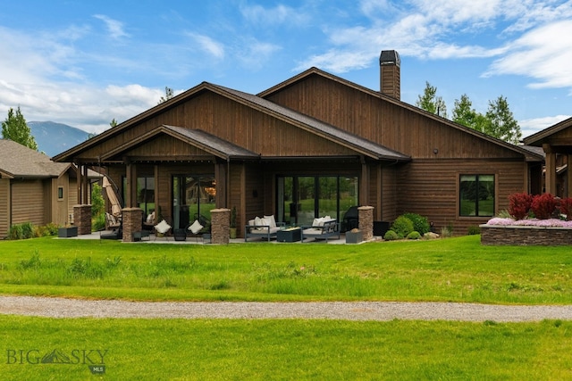 47 Wickwire, Bozeman, MT 59718 - rear view of house with a chimney, a patio, a lawn, a mountain view, and outdoor lounge area