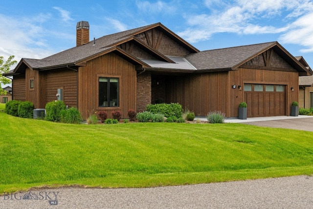 47 Wickwire, Bozeman, MT 59718 - view of front of home with a garage, a chimney, a front yard, asphalt driveway, and central air condition unit