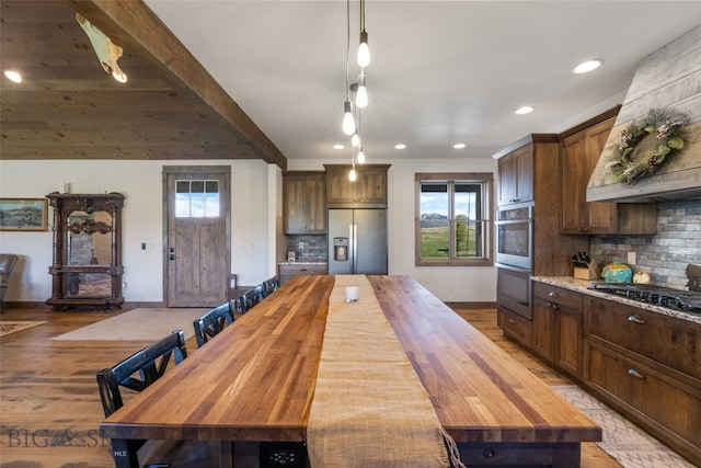 289 Montana Way, Ennis, MT 59729 - kitchen with appliances with stainless steel finishes, butcher block counters, baseboards, recessed lighting, and beam ceiling