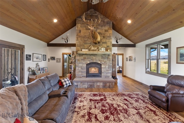 289 Montana Way, Ennis, MT 59729 - living area with vaulted ceiling, wood finished floors, a stone fireplace, baseboards, and wooden ceiling