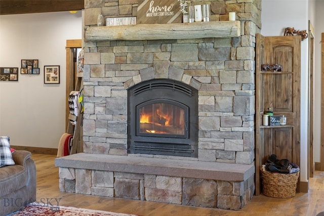 289 Montana Way, Ennis, MT 59729 - detailed view of wood finished floors, baseboards, and a stone fireplace