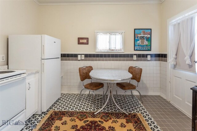 1116-1118 California St, Butte, MT 59701 - dining space with tile walls, crown molding, wainscoting, and tile patterned flooring
