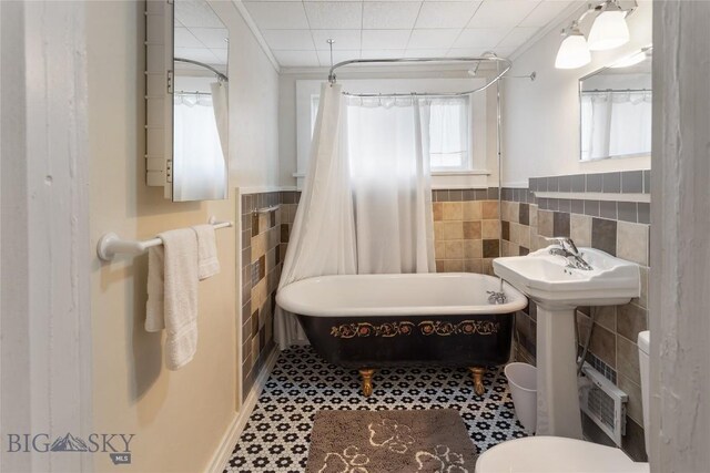 1116-1118 California St, Butte, MT 59701 - bathroom with tile walls, toilet, wainscoting, and shower / bath combo with shower curtain