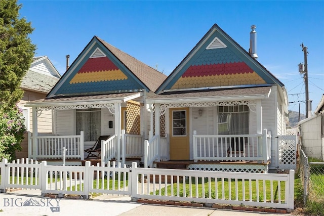 1116-1118 California St, Butte, MT 59701 - victorian house with covered porch, a fenced front yard, and a gate