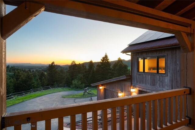 2355 Sawmill Rd, Bozeman, MT 59715 - wooden terrace featuring a wooded view and a barn
