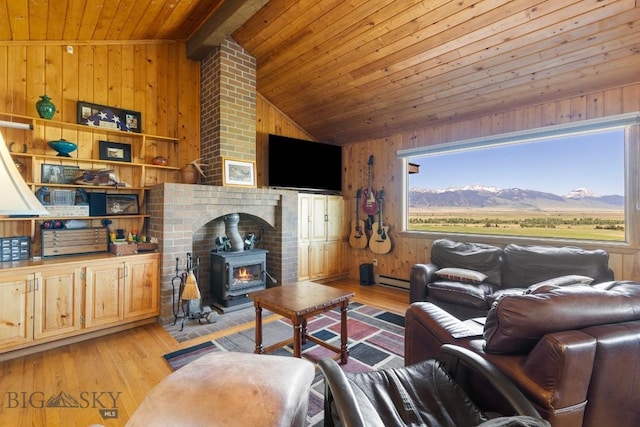 25 Trail Creek Rd, Ennis, MT 59729 - living area featuring wooden ceiling, vaulted ceiling, wood walls, light wood-style flooring, and a wood stove
