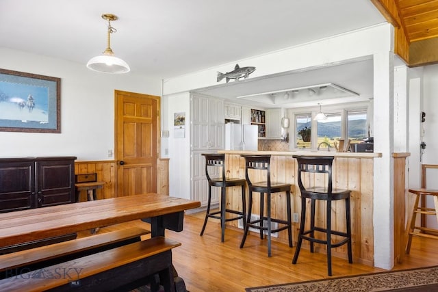 25 Trail Creek Rd, Ennis, MT 59729 - dining space with light wood-style floors and wainscoting