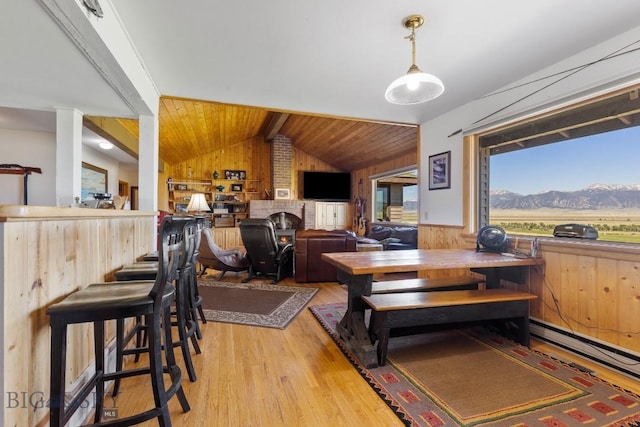 25 Trail Creek Rd, Ennis, MT 59729 - dining room with wood walls, light wood-style flooring, a wainscoted wall, wood ceiling, and baseboard heating