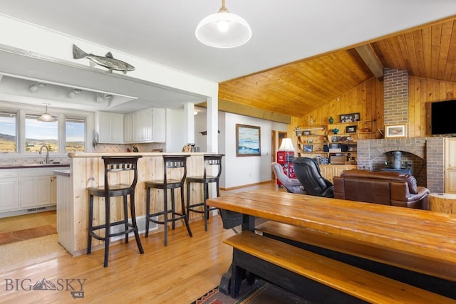 25 Trail Creek Rd, Ennis, MT 59729 - dining space with light wood-style flooring, wooden walls, and wood ceiling