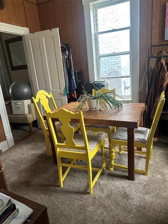905 W Copper, Butte, MT 59701 - dining space with healthy amount of natural light, carpet floors, and wood walls