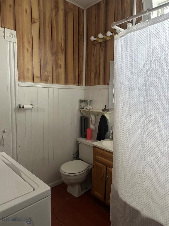 905 W Copper, Butte, MT 59701 - bathroom featuring vanity, toilet, washer / dryer, curtained shower, and wood walls