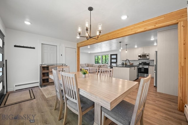 420 N 6th Ave, Bozeman, MT 59715 - dining room with baseboard heating, wood finished floors, a chandelier, and recessed lighting