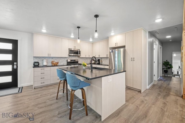 420 N 6th Ave, Bozeman, MT 59715 - kitchen with stainless steel appliances, dark countertops, a sink, light wood-type flooring, and recessed lighting