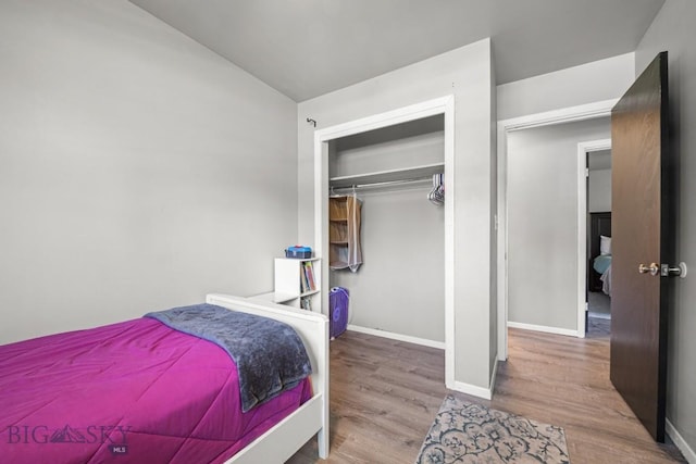 420 N 6th Ave, Bozeman, MT 59715 - bedroom with wood finished floors, vaulted ceiling, baseboards, and a closet