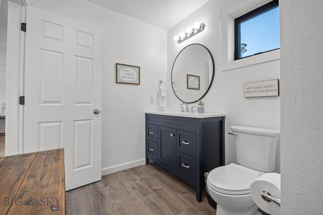 420 N 6th Ave, Bozeman, MT 59715 - bathroom featuring wood finished floors, vanity, toilet, and baseboards