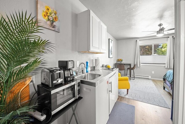 420 N 6th Ave, Bozeman, MT 59715 - kitchen with a sink, light wood finished floors, a ceiling fan, light countertops, and stainless steel microwave