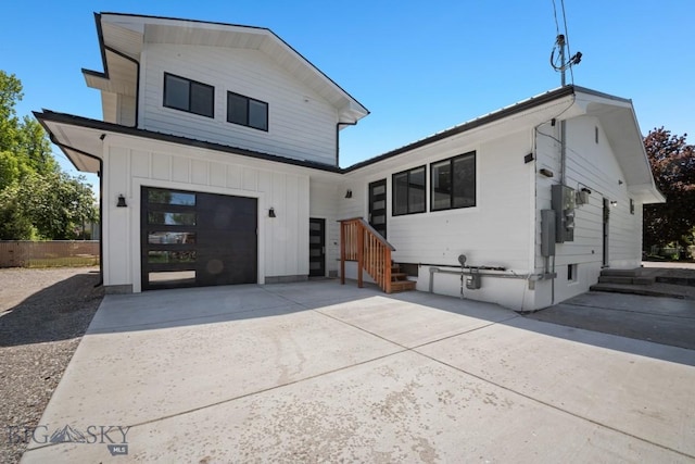 420 N 6th Ave, Bozeman, MT 59715 - view of front of house with board and batten siding, driveway, and a garage