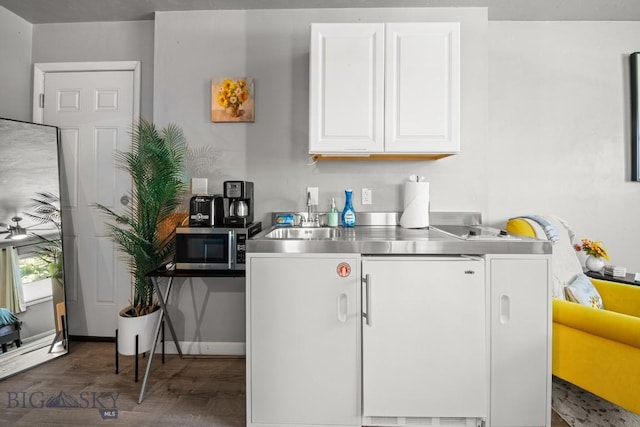 420 N 6th Ave, Bozeman, MT 59715 - kitchen with stainless steel counters, white cabinetry, stainless steel microwave, dark wood-style floors, and a sink