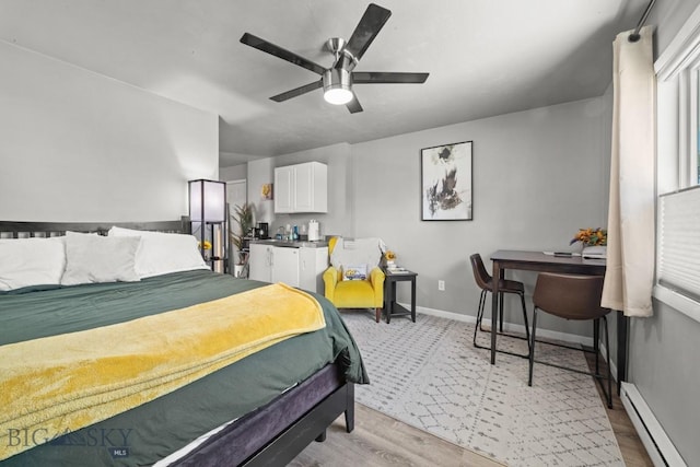 420 N 6th Ave, Bozeman, MT 59715 - bedroom with baseboard heating, a ceiling fan, light wood-type flooring, and baseboards