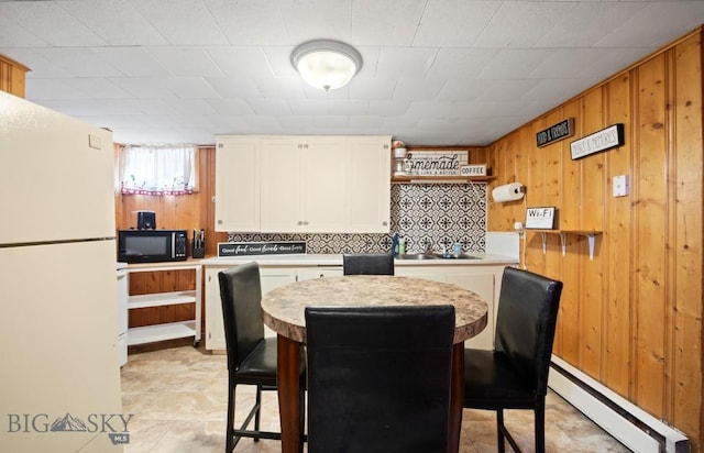 420 N 6th Ave, Bozeman, MT 59715 - dining room featuring a baseboard radiator and wood walls