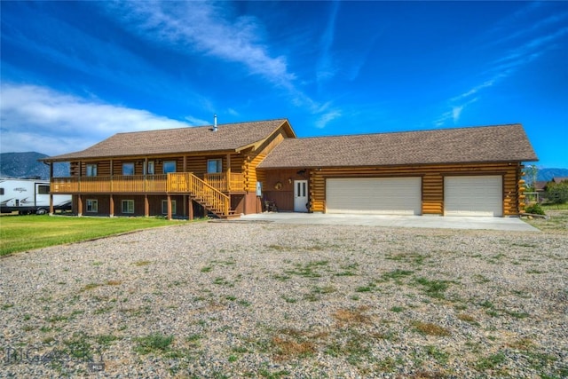 13 Coachman Ln, Mcallister, MT 59740 - cabin featuring log siding, a garage, driveway, a front yard, and stairway