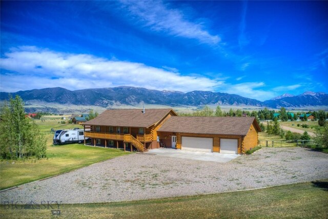 13 Coachman Ln, Mcallister, MT 59740 - log home with an attached garage, log siding, driveway, stairway, and roof with shingles