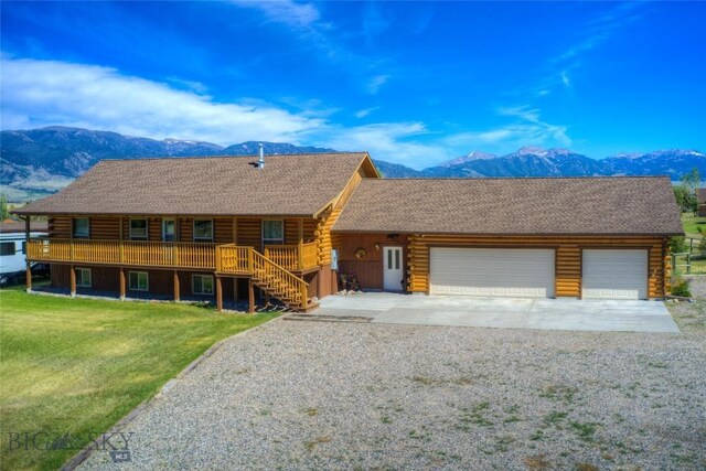 13 Coachman Ln, Mcallister, MT 59740 - log-style house featuring log exterior, a mountain view, concrete driveway, and a garage
