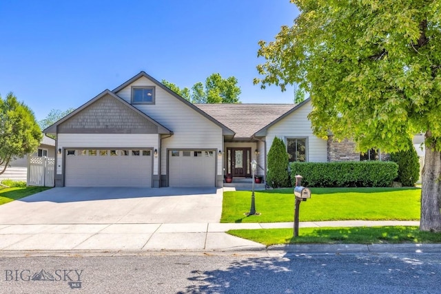 510 N 23rd, Bozeman, MT 59718 - view of front of home featuring a garage, a front yard, driveway, and stone siding
