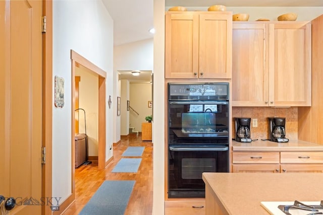 510 N 23rd, Bozeman, MT 59718 - kitchen featuring light brown cabinets, tasteful backsplash, light wood-type flooring, light countertops, and baseboards