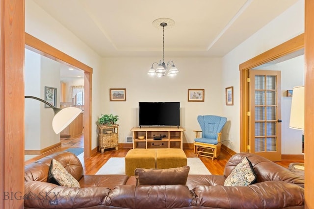 510 N 23rd, Bozeman, MT 59718 - living room with wood finished floors, a chandelier, baseboards, and a tray ceiling