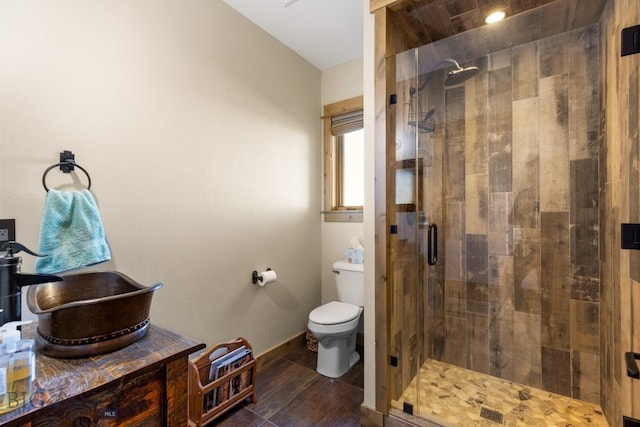 715 Bates Rd, Manhattan, MT 59741 - full bathroom featuring a stall shower, toilet, and baseboards