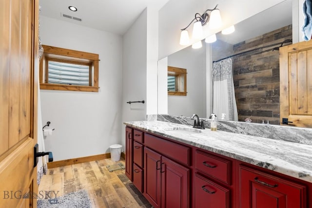 715 Bates Rd, Manhattan, MT 59741 - bathroom featuring wood finished floors, vanity, curtained shower, toilet, and baseboards