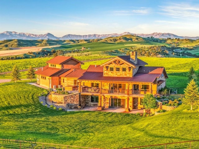 715 Bates Rd, Manhattan, MT 59741 - rear view of house featuring a patio area, a chimney, a mountain view, and a balcony