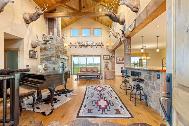 715 Bates Rd, Manhattan, MT 59741 - living area with high vaulted ceiling, a chandelier, wood ceiling with exposed beams, and wood finished floors
