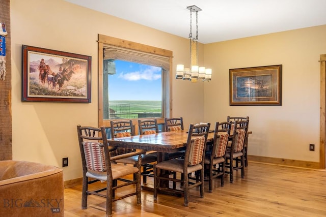 715 Bates Rd, Manhattan, MT 59741 - dining room featuring light wood finished floors, baseboards, and a chandelier