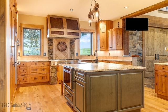 715 Bates Rd, Manhattan, MT 59741 - kitchen with a sink, plenty of natural light, light wood-style flooring, a kitchen island with sink, and recessed lighting